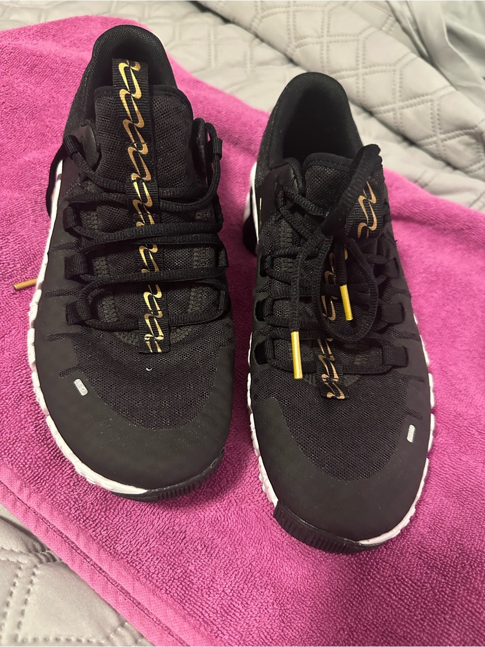 Women’s Nike Metcons Black Sneakers with Gold Accents and White Sole